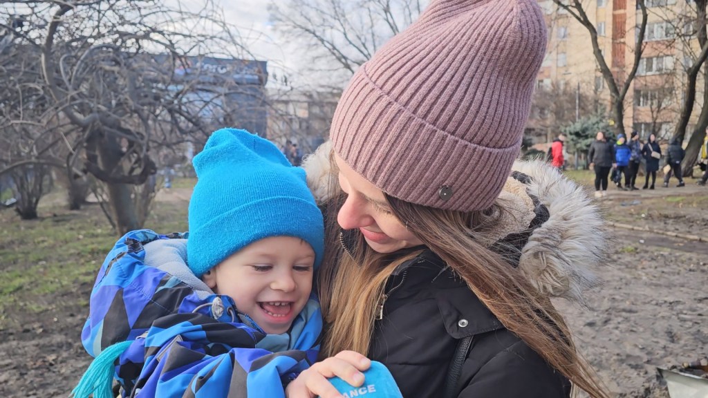 Katarina and her son Vovochka. The little boy is playing with the microphone.