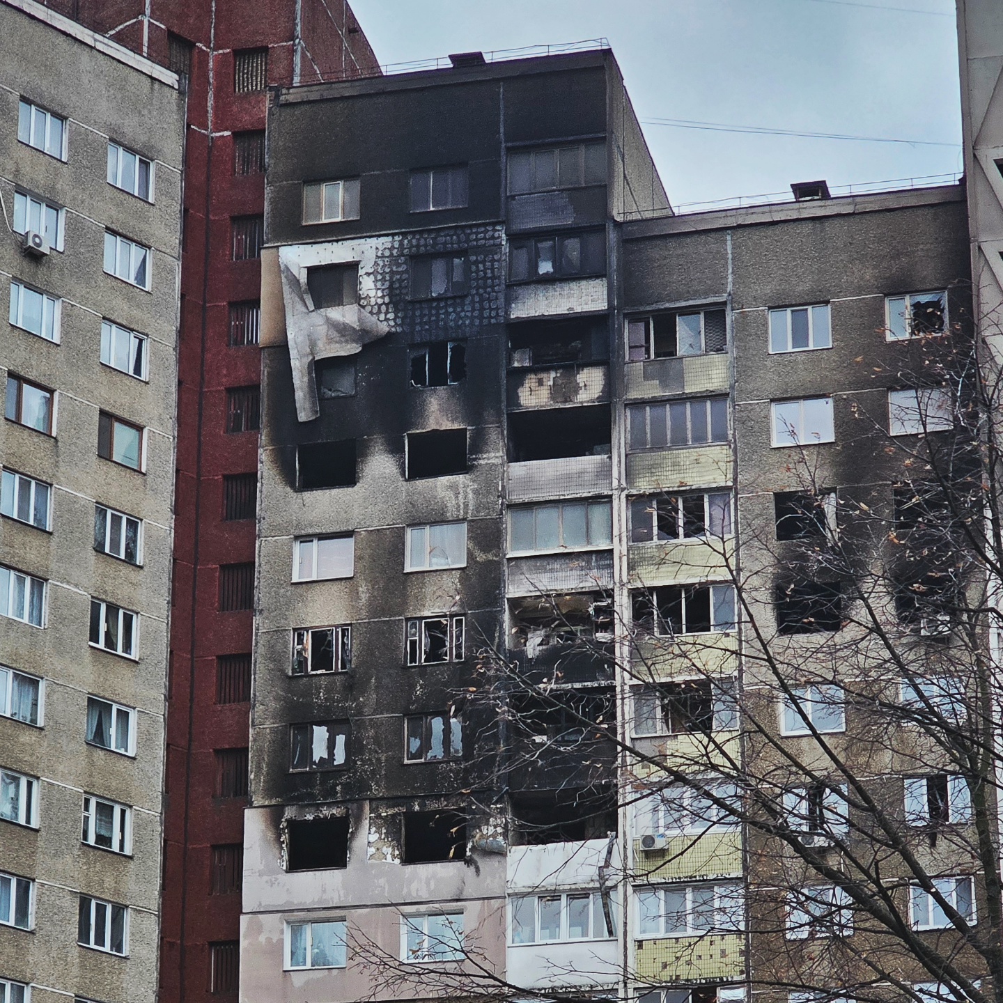 Close-up of the corner of the building worst affected by the strike - charred floors and broken windows. Parts of the facade are falling apart.